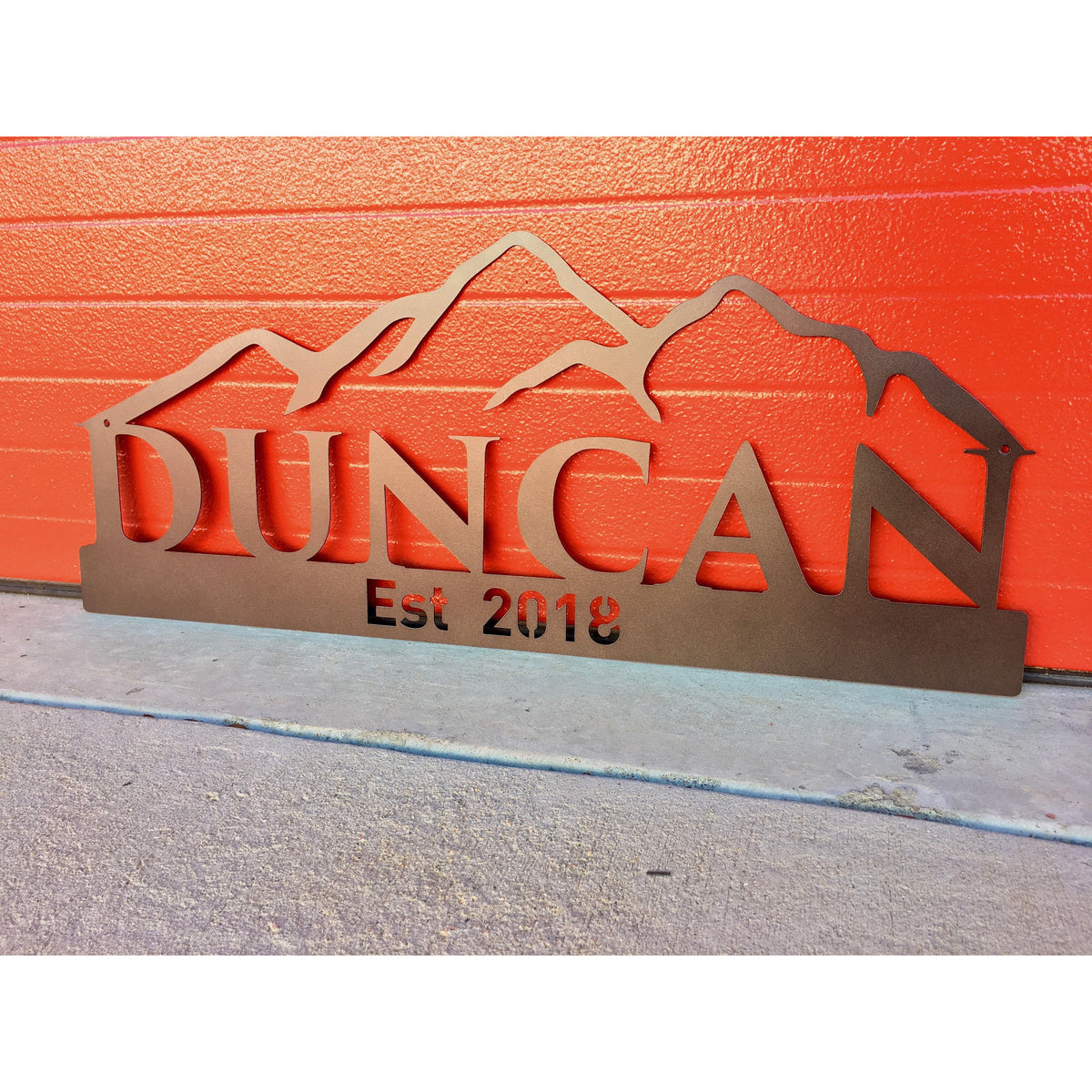 Custom Name sign with mountains on red background left view