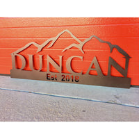 Custom Name sign with mountains on red background left view